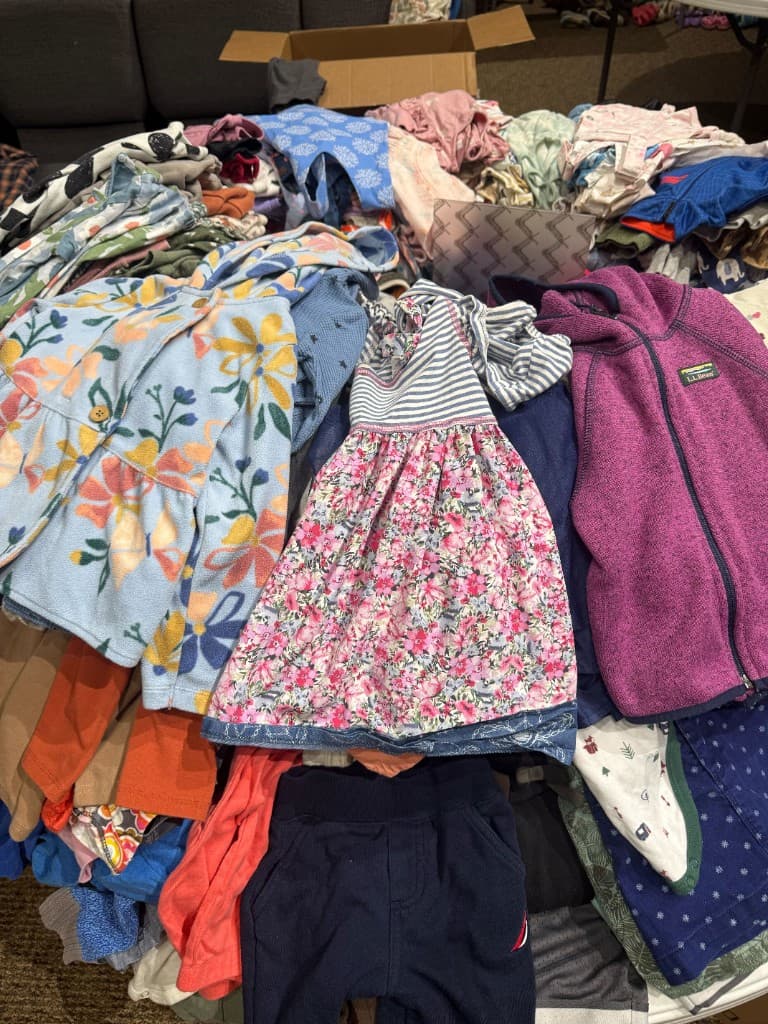 Large assortment of children's jackets, dresses, and pants ready to browse