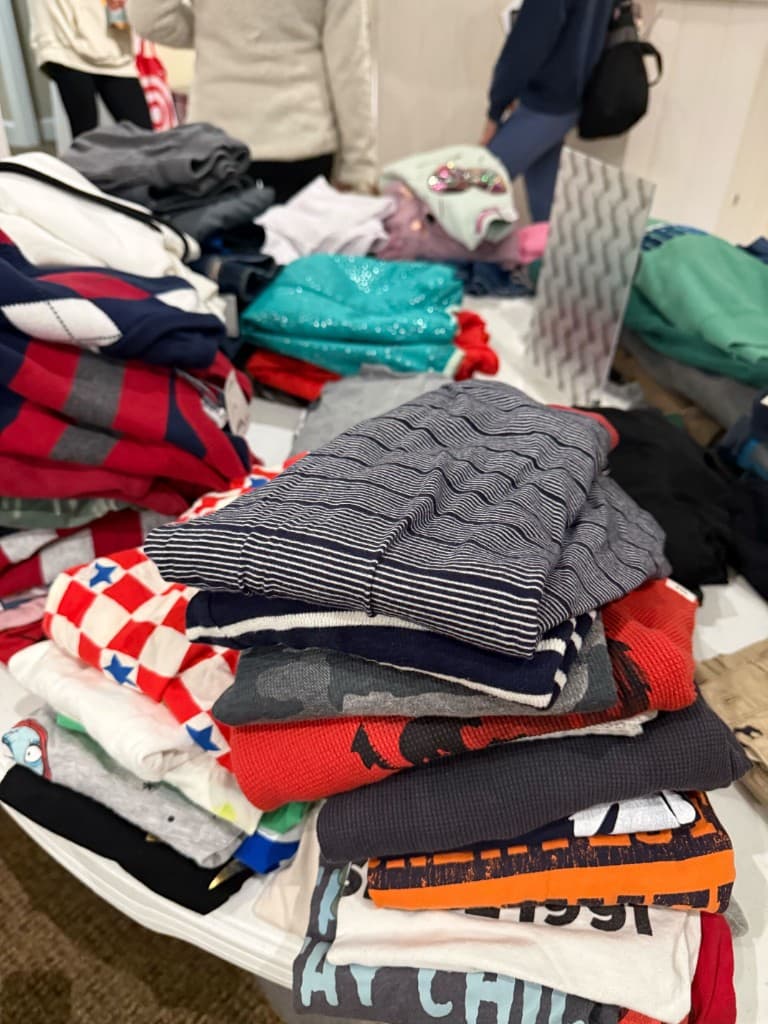Close-up of folded shirts stacked on a white table